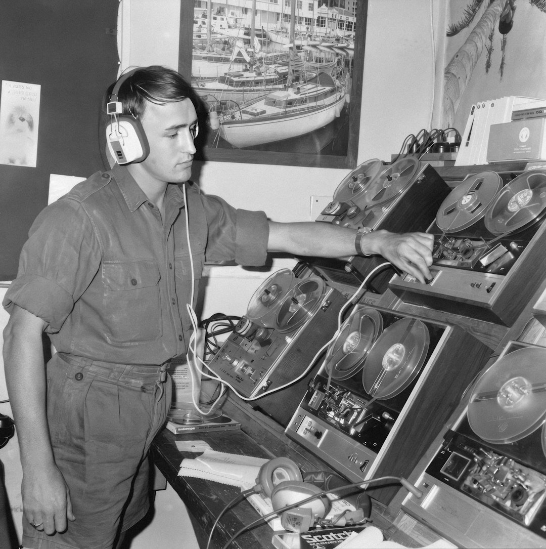 Portrait of a male field transmission technician with a headset around his neck