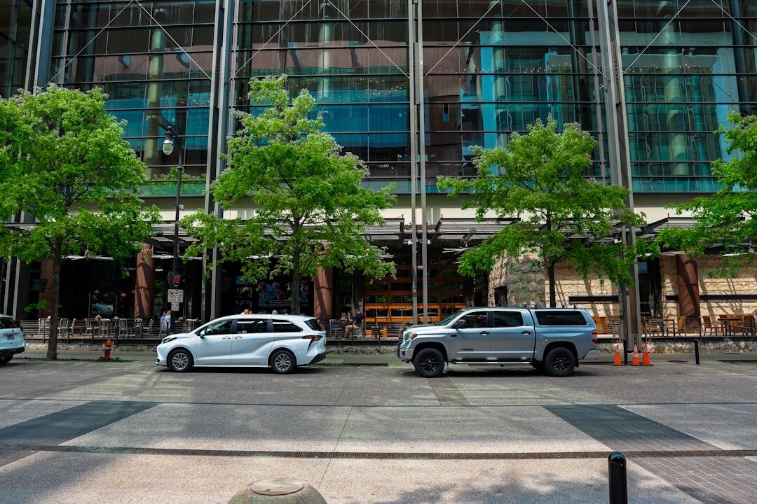 Modern technical office building with broadcast vehicles parked outside